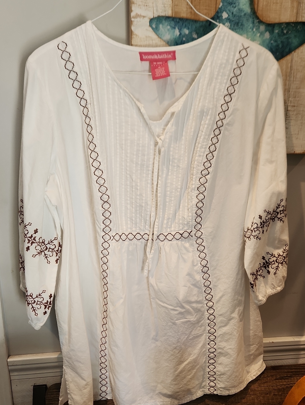 Woman Within White Tunic with Brown Embroidery